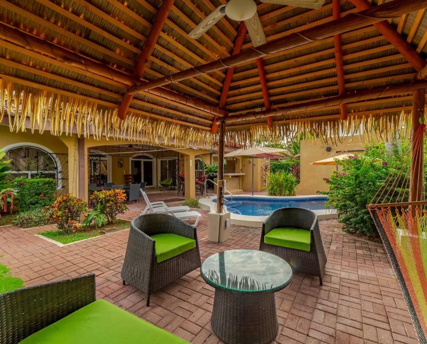 Covered outdoor lounge under the thatched rancho